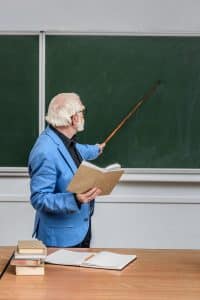 Elderly teacher lecturing with a pointer stick